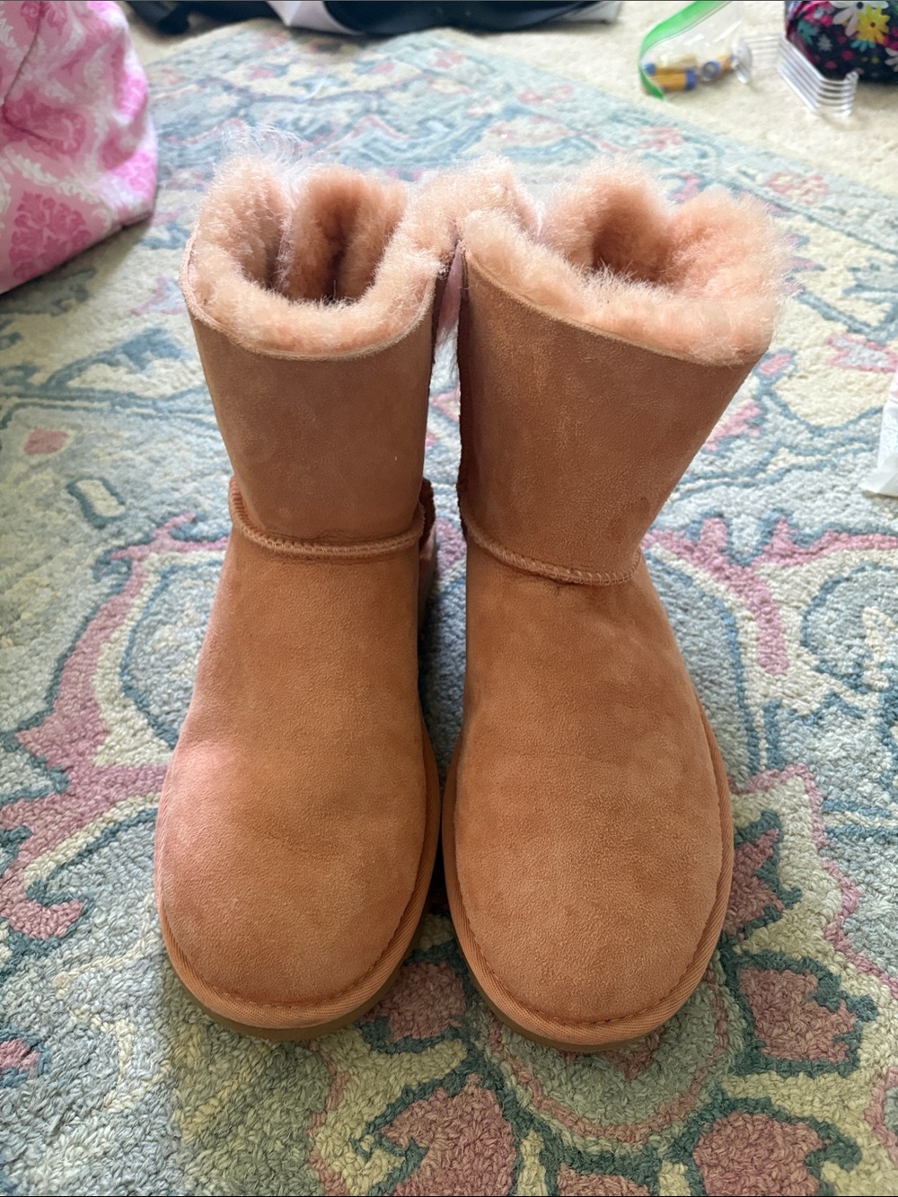 Woman’s Pink Ugg Boots With Fuzzy Bow on Back